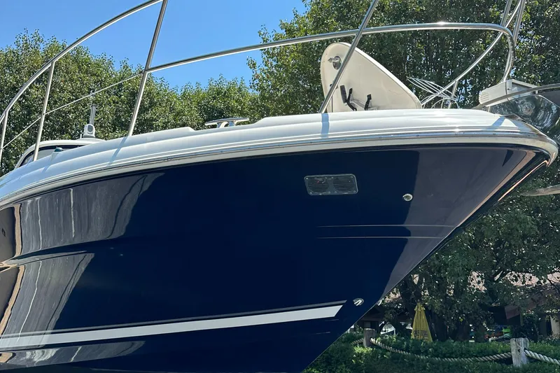 Slide: The Image of 2004 Sea Ray 390 Sundancer boat with sleek blue hull. - 17