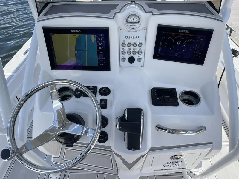 Slide: The Image of Control console of 2023 Velocity 26 BAY HYBRID boat with dual Simrad displays. - 19