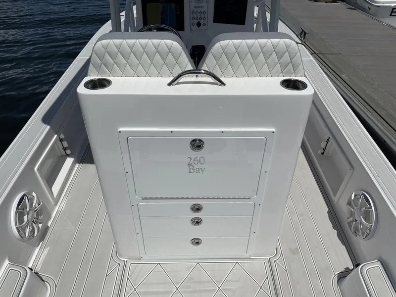 Slide: The Image of 2023 Velocity 26 BAY HYBRID boat interior with diamond-stitched seats and storage compartments. - 5