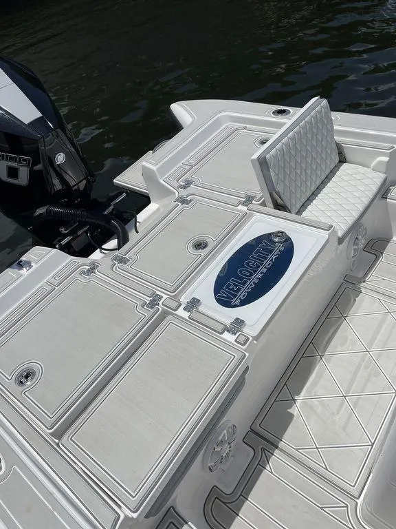 Slide: The Image of 2023 Velocity 26 BAY HYBRID boat deck with seating and storage compartments. - 8
