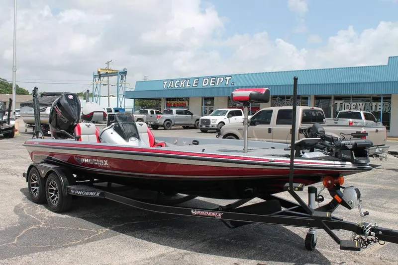 Slide: The Image of 2025 Phoenix 921 ELITE bass boat on trailer in front of Tackle Dept. store. - 3