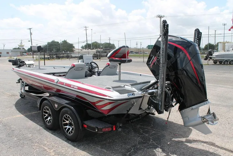 Slide: The Image of 2025 Phoenix 921 ELITE fishing boat with powerful outboard motor and sleek design. - 4