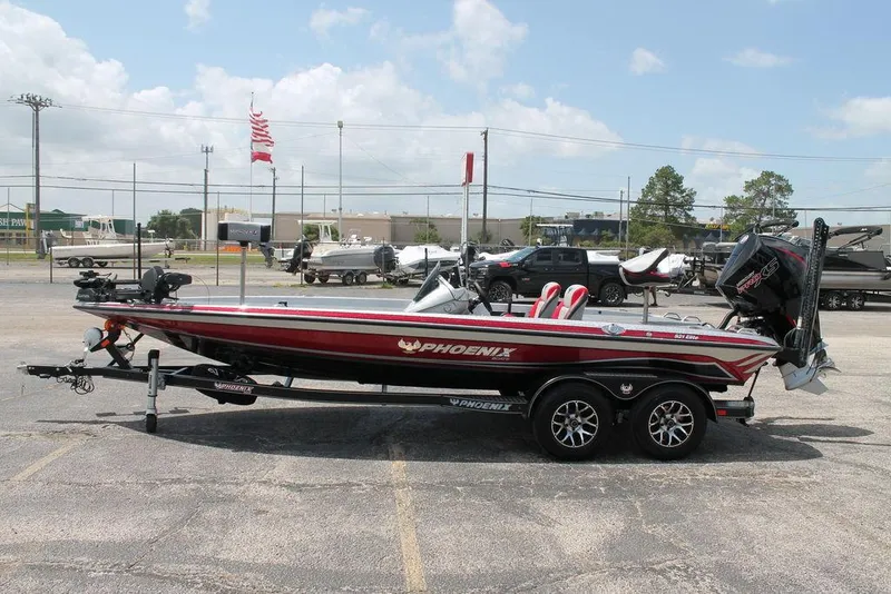 Slide: The Image of 2025 Phoenix 921 ELITE bass boat on trailer in parking lot. - 5