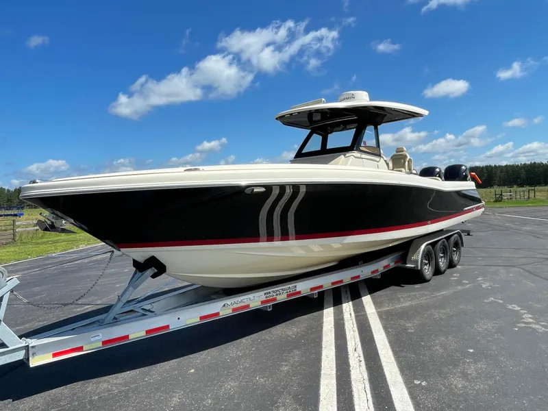 The Image of 2019 Chris-Craft Catalina 34 boat on a trailer under a clear blue sky. - 0