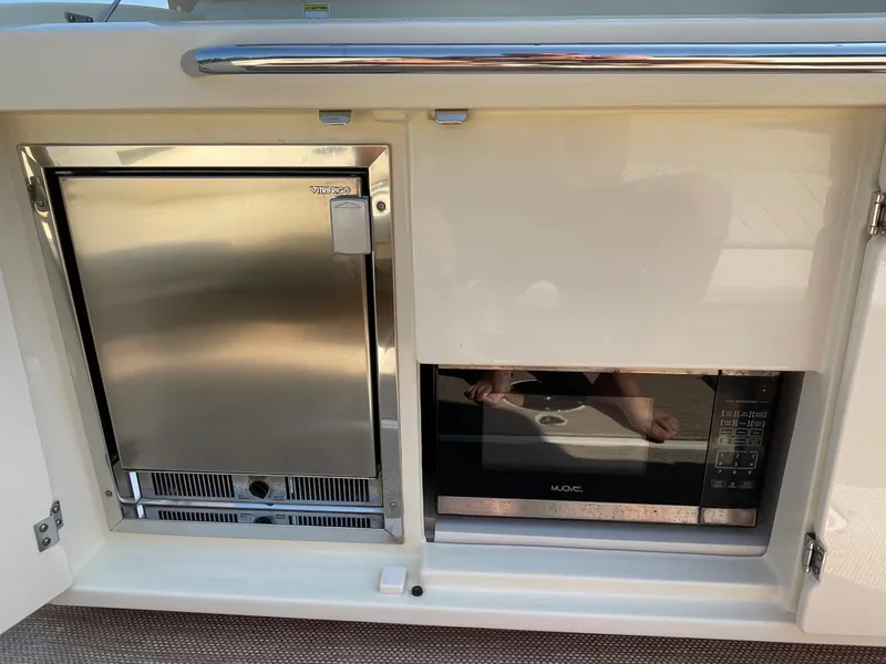 Slide: The Image of 2019 Chris-Craft Catalina 34 galley with stainless steel fridge and microwave. - 16