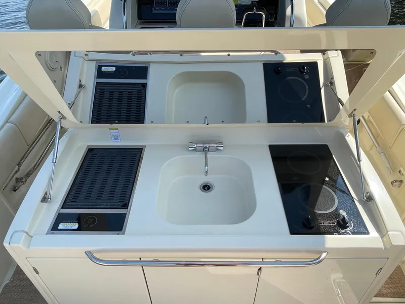 Slide: The Image of 2019 Chris-Craft Catalina 34 boat kitchen with sink, stove, and grill. - 19