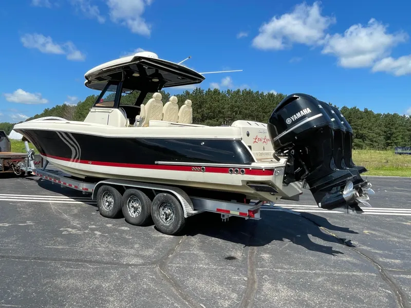 Slide: The Image of 2019 Chris-Craft Catalina 34 boat on a trailer with twin Yamaha outboard engines. - 2