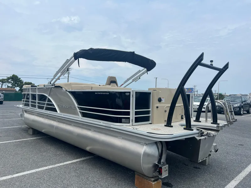 Slide: The Image of 2024 Berkshire 23RFC STS 2.75 pontoon boat in a parking lot. - 1