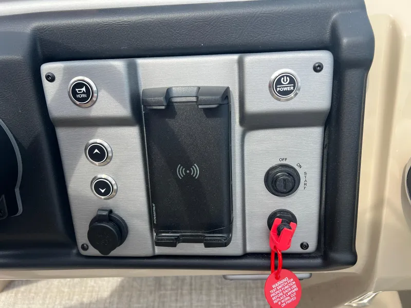 Slide: The Image of Control panel of 2024 Berkshire 23RFC STS 2.75 boat with power and ignition buttons. - 11