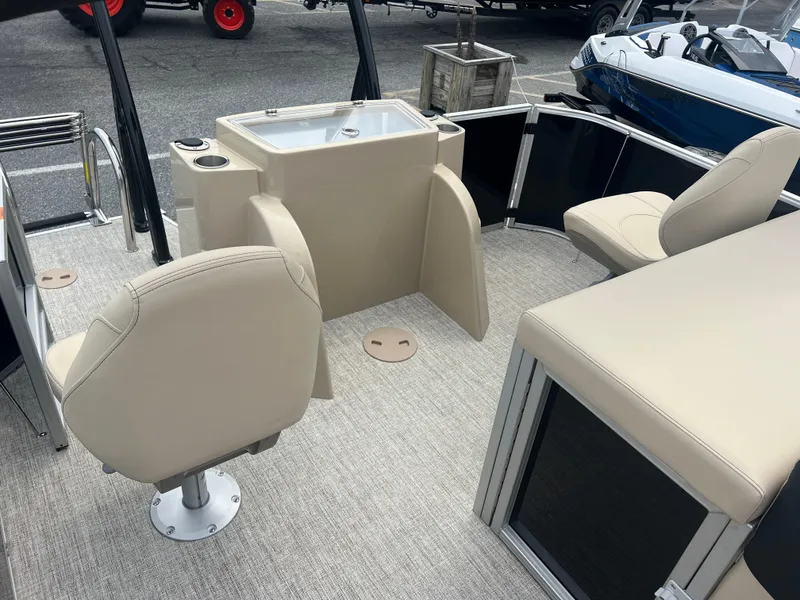 Slide: The Image of 2024 Berkshire 23RFC STS 2.75 boat interior with beige seating and a sink. - 13