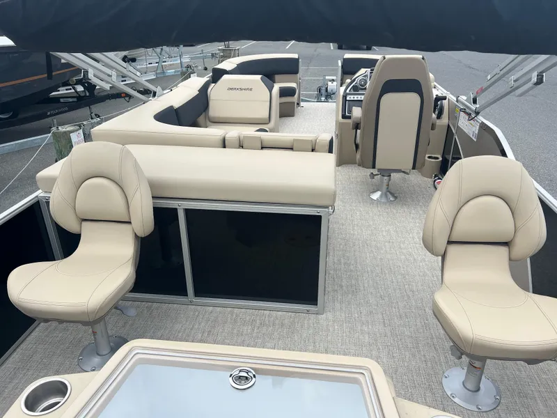 Slide: The Image of 2024 Berkshire 23RFC STS 2.75 pontoon boat interior with beige seating and helm. - 16