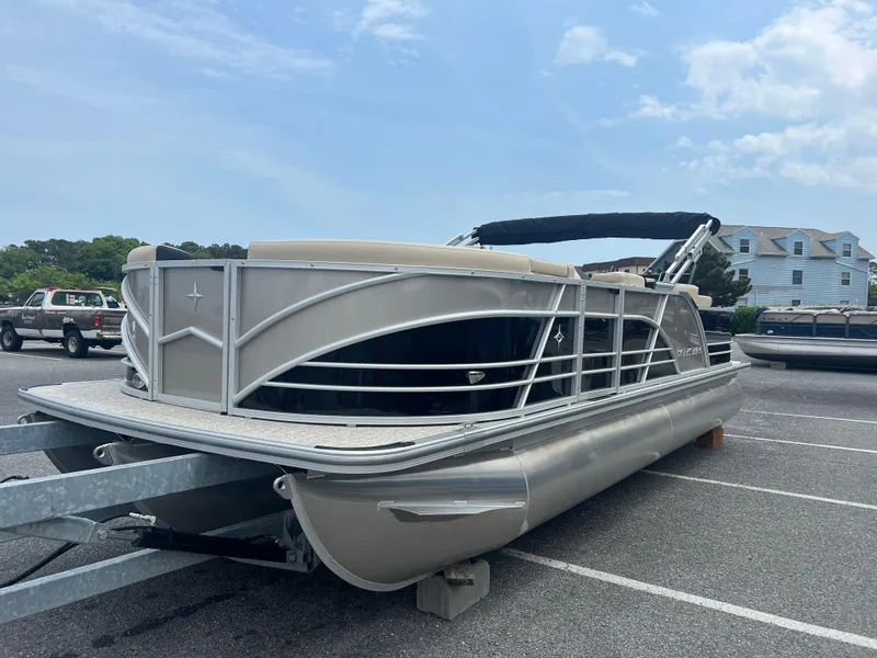 Slide: The Image of 2024 Berkshire 23RFC STS 2.75 pontoon boat in a parking lot. - 2