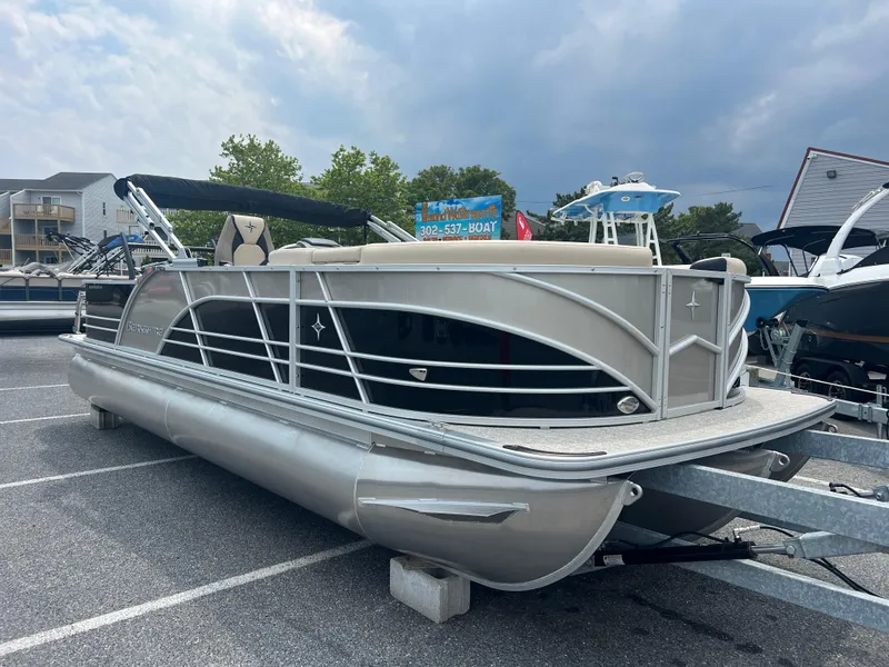 Slide: The Image of 2024 Berkshire 23RFC STS 2.75 pontoon boat in a parking lot. - 3