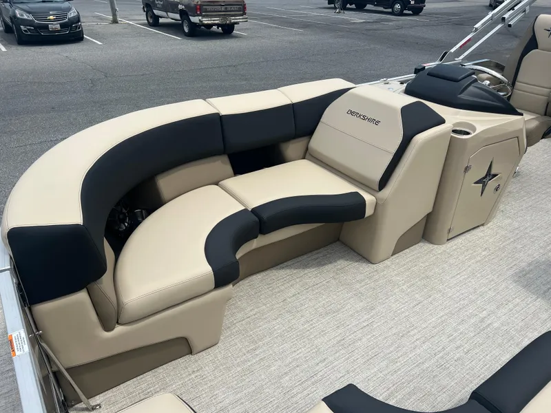 Slide: The Image of 2024 Berkshire 23RFC STS 2.75 pontoon boat with beige and black seating. - 6