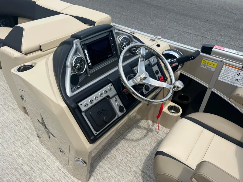Slide: The Image of 2024 Berkshire 23RFC STS 2.75 boat dashboard with steering wheel and control panel. - 9