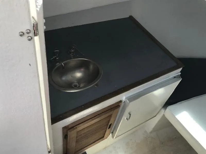 Slide: The Image of 2003 Eastern 27' Lobster boat interior sink and storage area. - 19