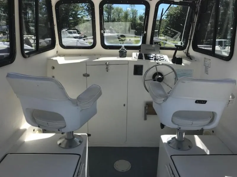 Slide: The Image of Interior of a 2003 Eastern 27' Lobster boat with two white captain chairs. - 20