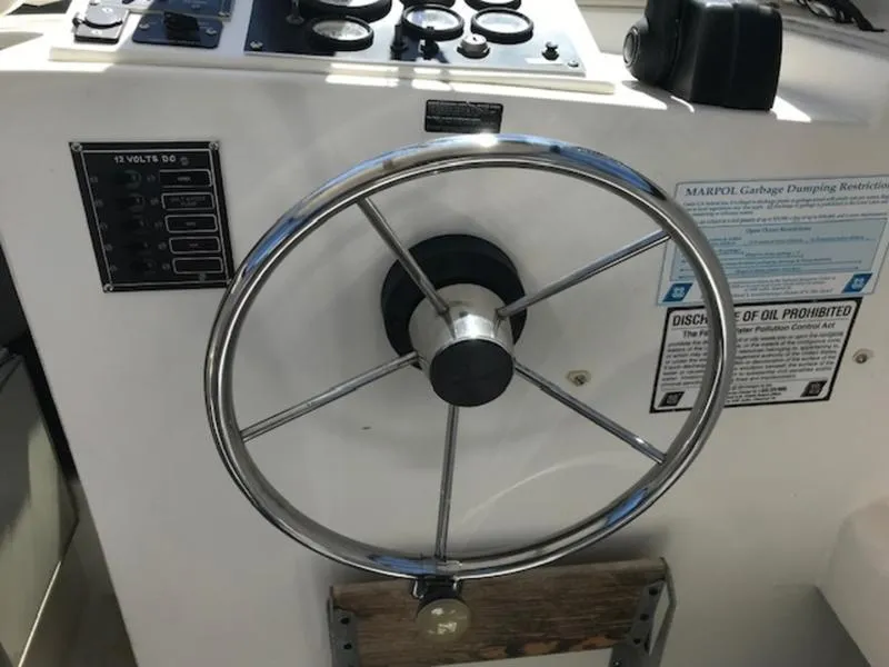 Slide: The Image of Steering wheel and control panel of a 2003 Eastern 27' Lobster boat. - 3