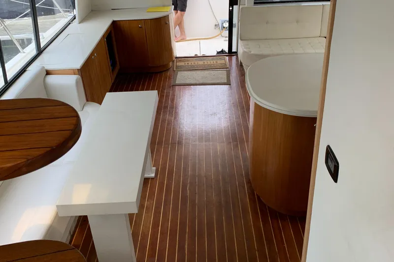 Slide: The Image of 1999 Bayliner 5788 Pilot House Motoryacht interior with wood flooring and modern furnishings. - 11