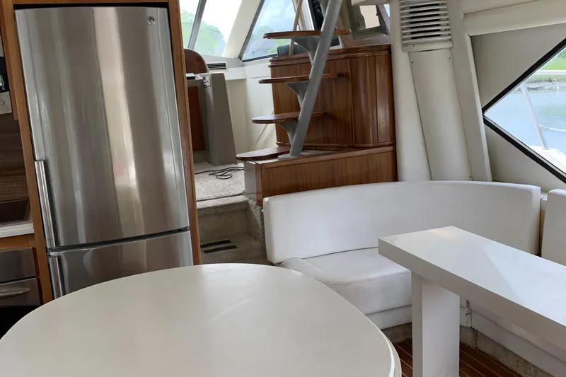 Slide: The Image of Interior of 1999 Bayliner 5788 Pilot House Motoryacht with modern kitchen and seating area. - 12