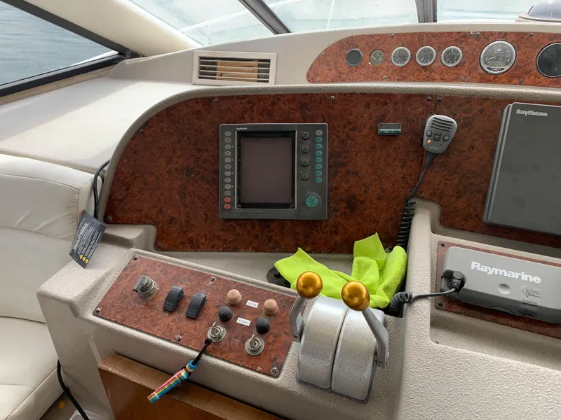 Slide: The Image of 1999 Bayliner 5788 Pilot House Motoryacht helm with navigation controls and instruments. - 16