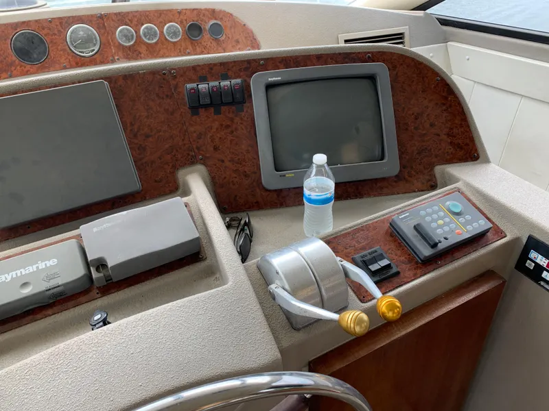 Slide: The Image of 1999 Bayliner 5788 Pilot House Motoryacht helm with controls and navigation equipment. - 18