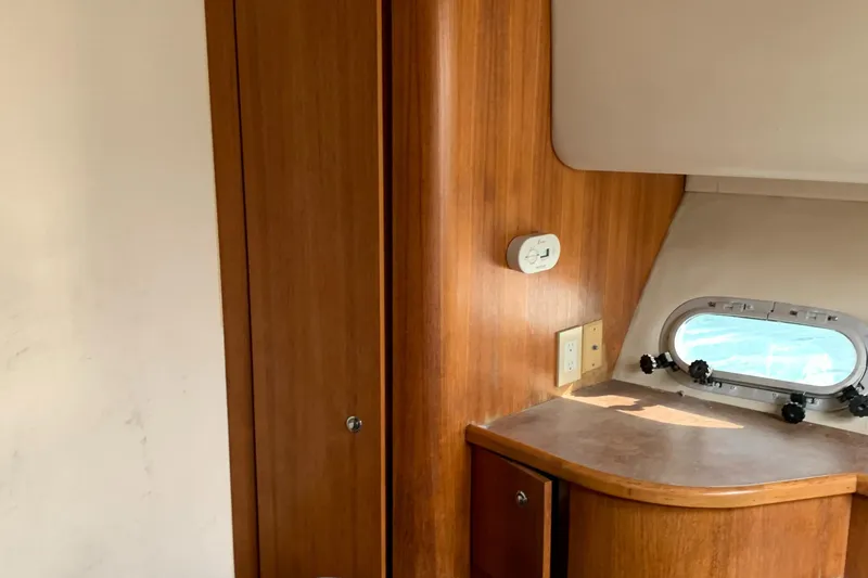 Slide: The Image of Interior of 1999 Bayliner 5788 Pilot House Motoryacht with wooden cabinetry and porthole window. - 28