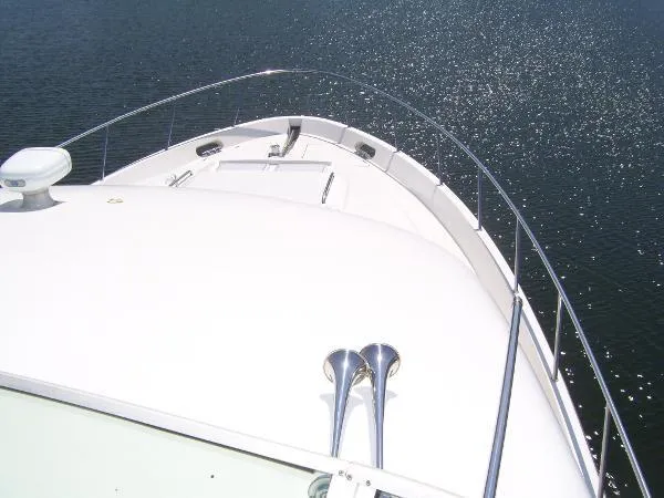 Slide: The Image of 1999 Bayliner 5788 Pilot House Motoryacht bow view on sparkling water. - 3