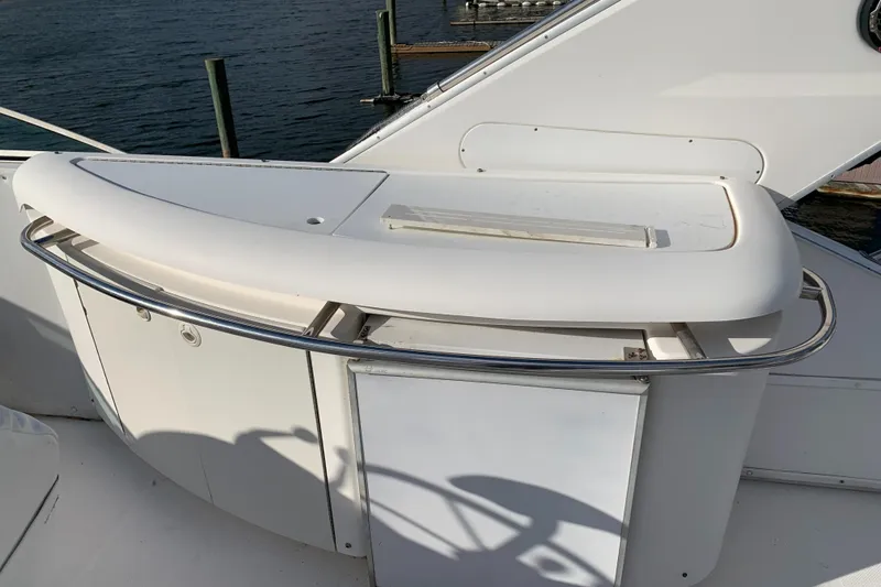 Slide: The Image of 1999 Bayliner 5788 Pilot House Motoryacht deck with sleek white railing and storage. - 36