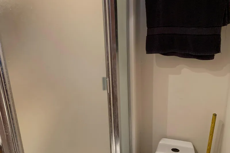 Slide: The Image of Bathroom interior of 1999 Bayliner 5788 Pilot House Motoryacht with shower and towel. - 40