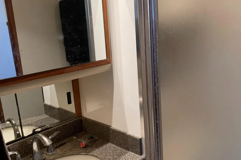 Slide: The Image of Bathroom interior of 1999 Bayliner 5788 Pilot House Motoryacht with sink and shower. - 43