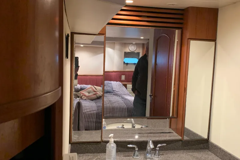 Slide: The Image of 1999 Bayliner 5788 Pilot House Motoryacht interior with bedroom and bathroom vanity. - 44