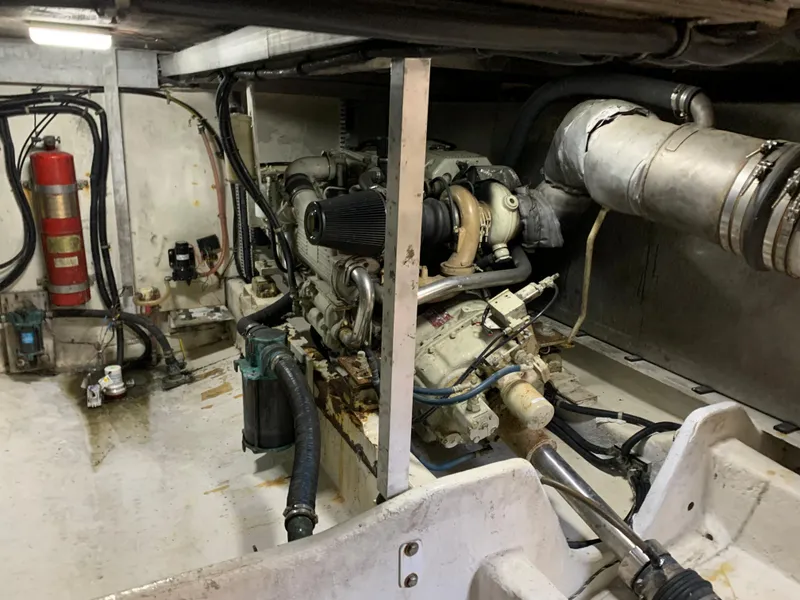 Slide: The Image of Engine room of 1999 Bayliner 5788 Pilot House Motoryacht with visible machinery and fire extinguisher. - 48