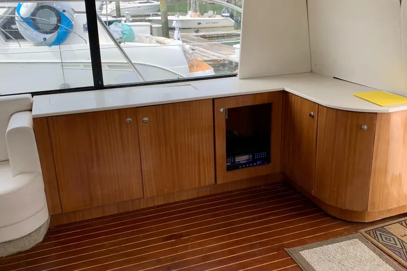 Slide: The Image of 1999 Bayliner 5788 Pilot House Motoryacht interior with wooden cabinetry and sleek design. - 8