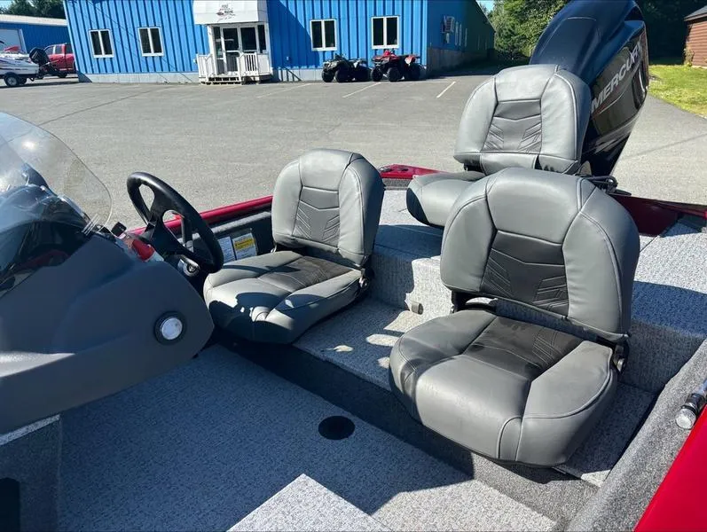 Slide: The Image of 2024 Tracker Pro 170 boat interior with gray seats and steering wheel. - 3