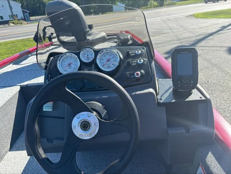 Slide: The Image of 2024 Tracker Pro 170 boat dashboard with steering wheel, gauges, and GPS device. - 5