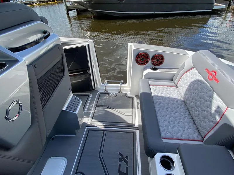 Slide: The Image of 2025 Fountain 38 SCX boat interior with gray seating and red speakers. - 15