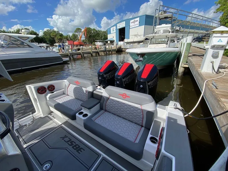 Slide: The Image of Interior of 2025 Fountain 38 SCX boat with gray seating and red speakers. - 16
