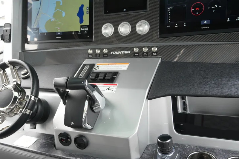Slide: The Image of 2025 Fountain 38 SCX boat interior with luxurious gray seating and red accents. - 25