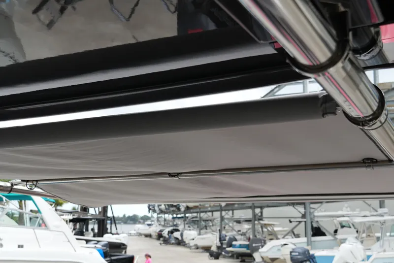 Slide: The Image of 2025 Fountain 38 SCX boat with retractable canopy in marina setting. - 37