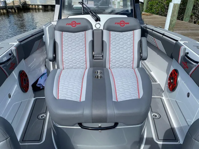 Slide: The Image of 2025 Fountain 38 SCX boat on a trailer, side view with trees and sky background. - 8