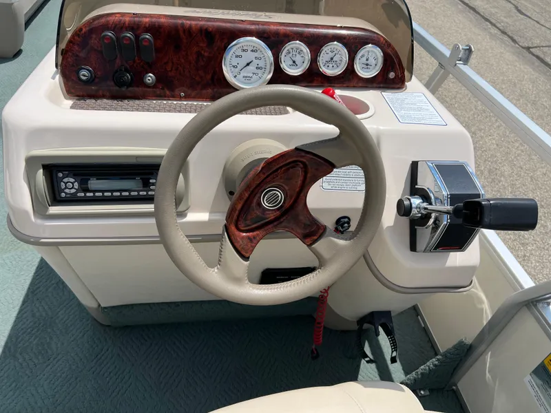 Slide: The Image of 2006 Sun Tracker PB 24 boat steering console with gauges and controls. - 13
