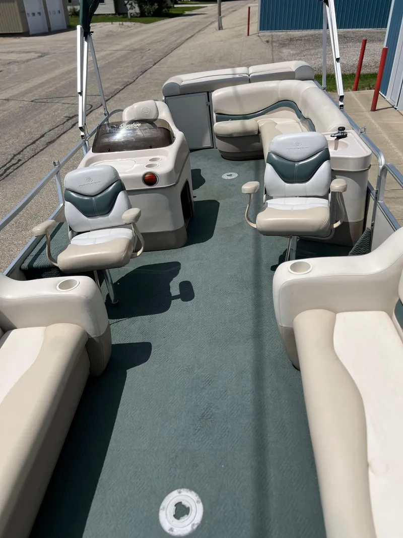 Slide: The Image of 2006 Sun Tracker PB 24 pontoon boat interior with seating and console. - 16