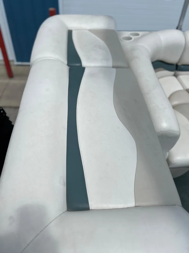 Slide: The Image of 2006 Sun Tracker PB 24 boat seat with white and gray upholstery. - 18