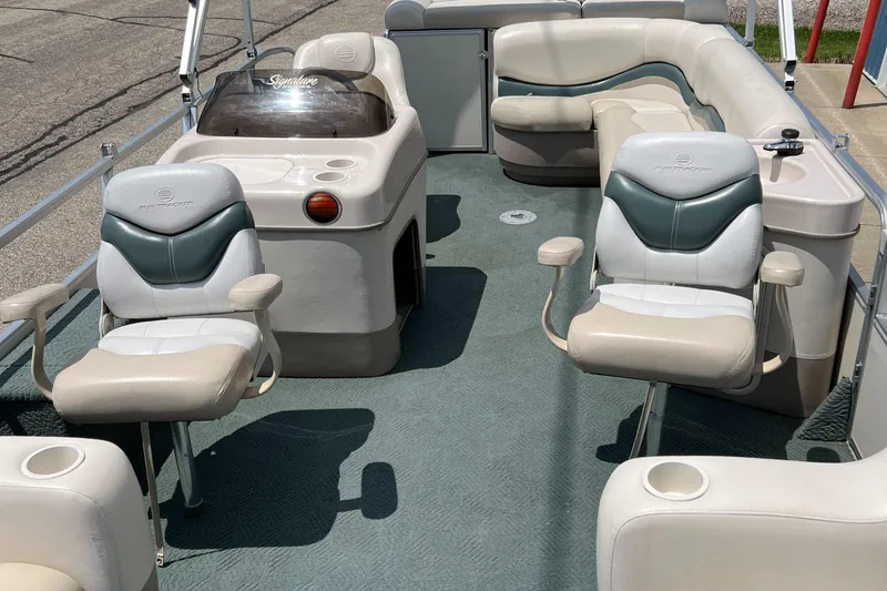 Slide: The Image of 2006 Sun Tracker PB 24 pontoon boat interior with seating and console. - 25