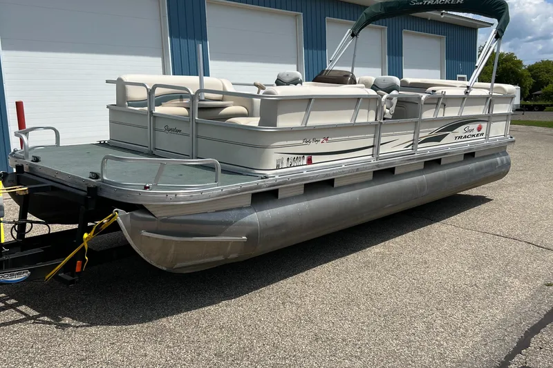 Slide: The Image of 2006 Sun Tracker PB 24 pontoon boat parked on a trailer. - 27