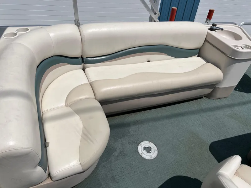 Slide: The Image of 2006 Sun Tracker PB 24 pontoon boat seating area with white and beige upholstery. - 5