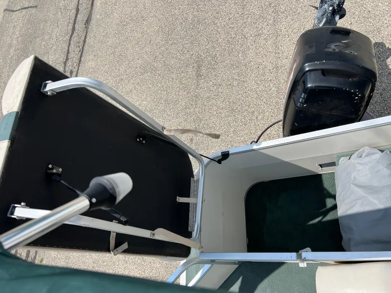 Slide: The Image of 2006 Sun Tracker PB 24 boat interior with motor and seating area. - 6