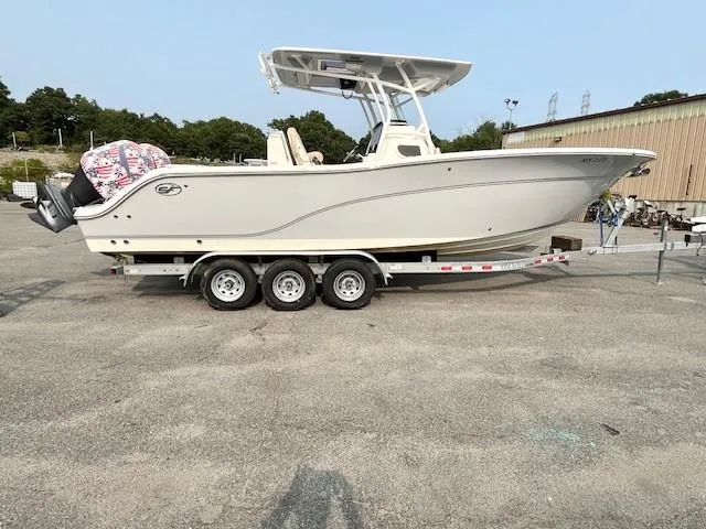 The Image of 2018 Sea Fox 288 Commander boat on a trailer in a parking lot. - 1