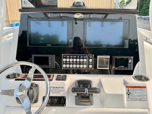 Slide: The Image of 2018 Sea Fox 288 Commander dashboard with dual Garmin displays and controls. - 19